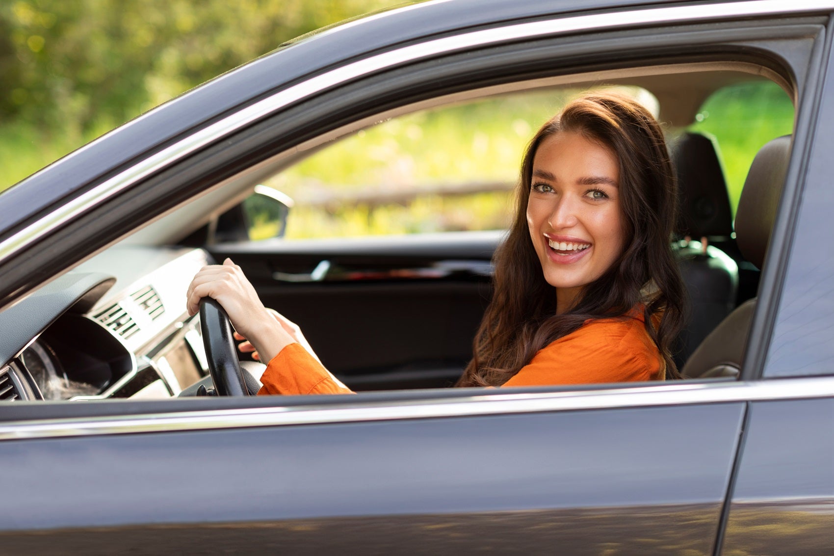 woman smiling while sitting in vehicle