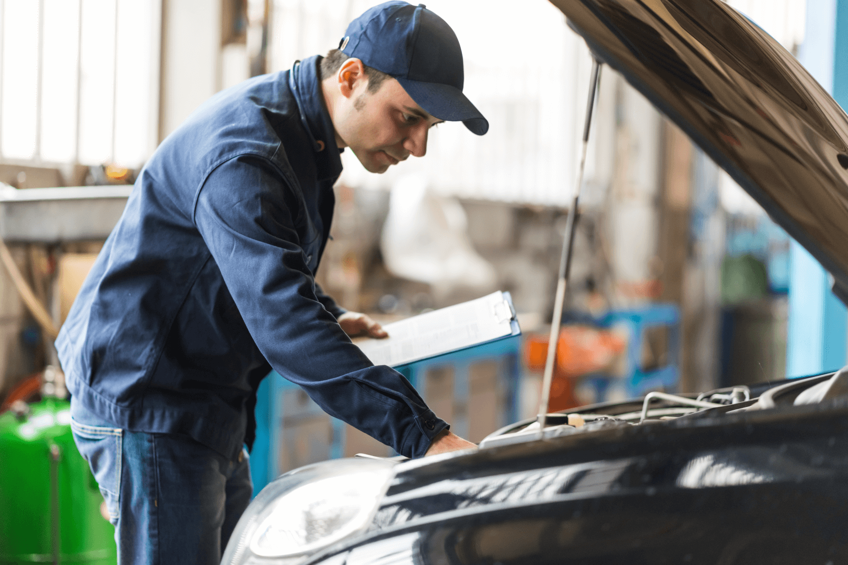service technician inspecting car engine